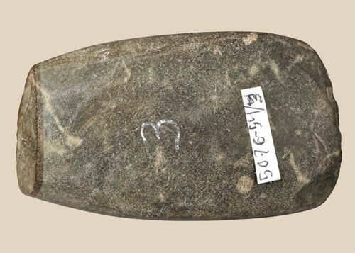 Authentic Pre-Columbian Andean ground-stone axe from Ecuador or Peru, 200–800 AD. Utilitarian tool with fully ground faces, steep beveled cutting edge, and rounded edge from repeated use. Original archaeological tag included. Reflects ancient craftsmanship, daily life, and technological skill of Andean civilizations.