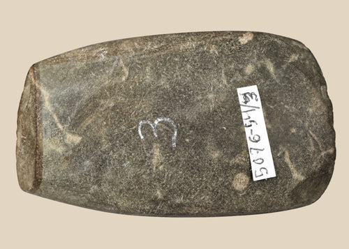 Authentic Pre-Columbian Andean ground-stone axe from Ecuador or Peru, 200–800 AD. Utilitarian tool with fully ground faces, steep beveled cutting edge, and rounded edge from repeated use. Original archaeological tag included. Reflects ancient craftsmanship, daily life, and technological skill of Andean civilizations.
