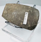 Side view of a Pre-Columbian Andean stone axe displaying its thick profile and steeply beveled cutting edge.