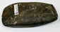 Reverse view of a Pre-Columbian stone tool from the Andean region showing hand-worked surfaces and archaeological collection markings.