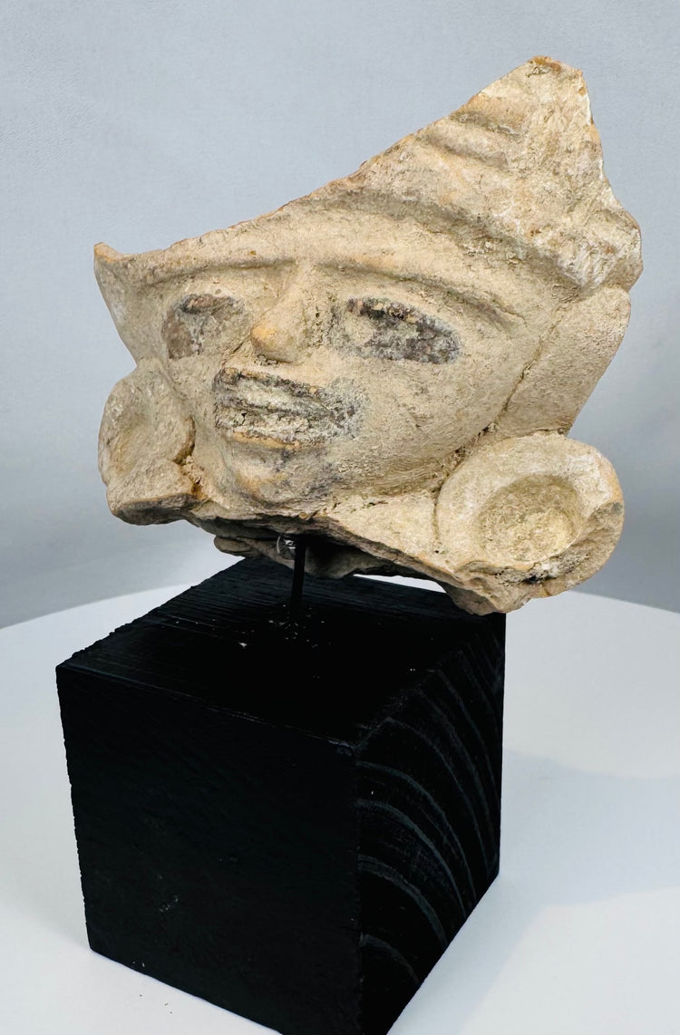 Ancient Mexican terracotta face fragment mounted for display, dating to the Late Classic–Postclassic period.