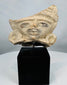 Pre-Columbian architectural or ceremonial terracotta fragment with expressive facial features and elaborate headdress.