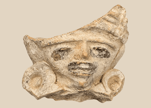 Pre-Columbian terracotta figural fragment depicting a stylized human face with large earspools and fan-shaped headdress, Mesoamerica, circa 600–1200 CE.
