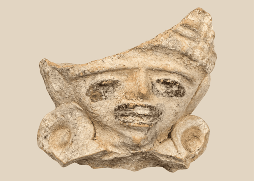 Pre-Columbian terracotta figural fragment depicting a stylized human face with large earspools and fan-shaped headdress, Mesoamerica, circa 600–1200 CE.