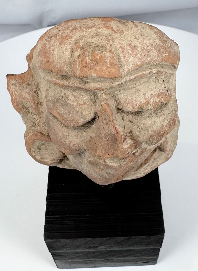 Ancient Mexican ceramic head with stylized facial features and possible headdress band