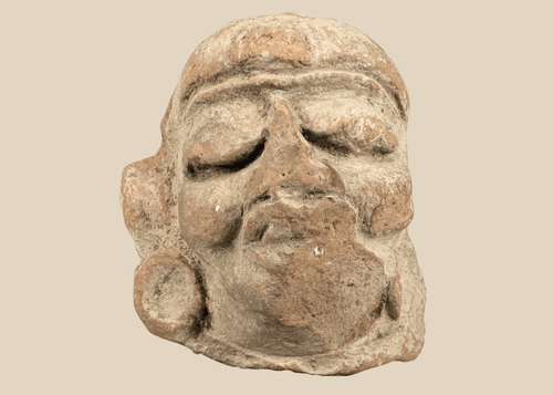 Ancient Mesoamerican terracotta head fragment with prominent circular earspools and traces of pigment