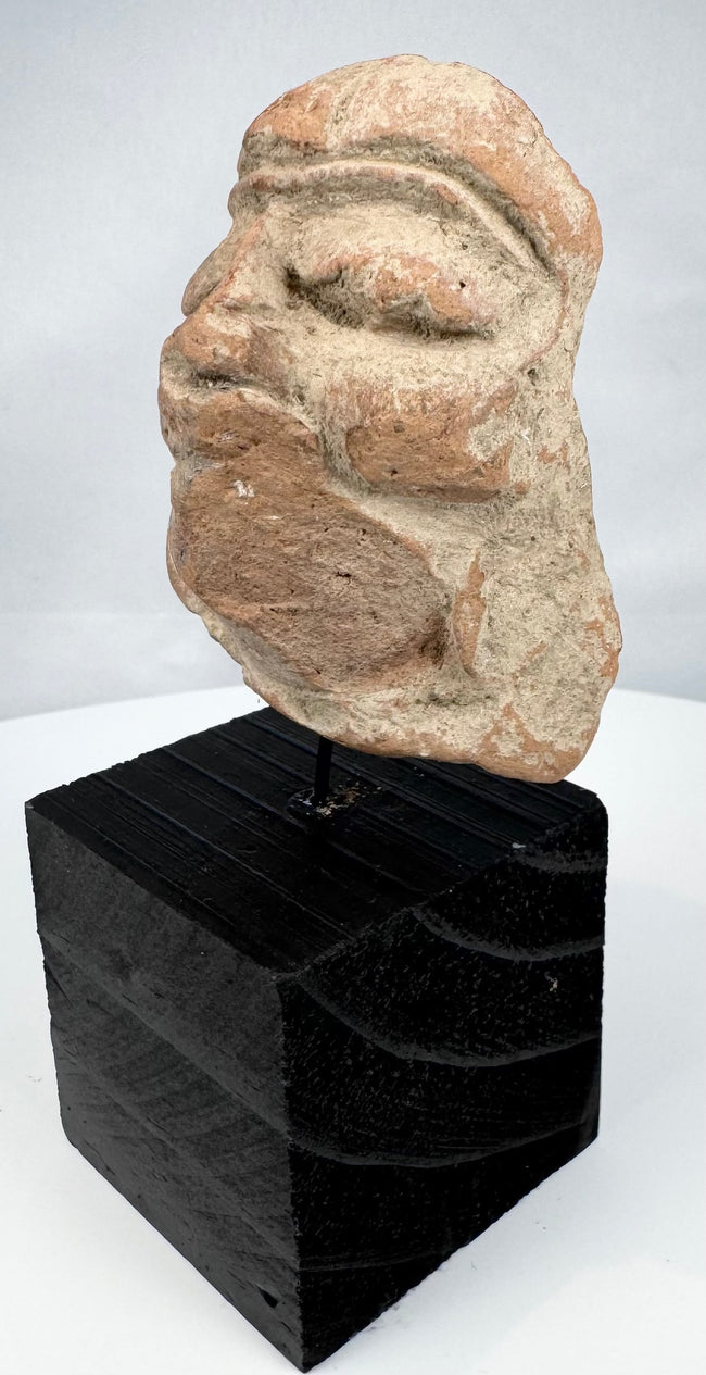Mesoamerican ceramic head fragment with broad nose, full lips, and ear ornaments
