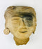 Angled top view displaying sculpted coiffure and mineral deposits on surface
