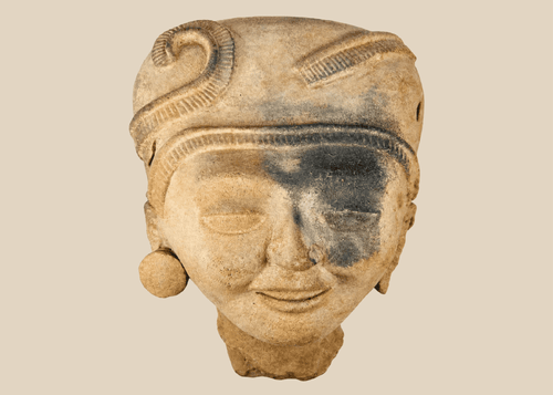 Pre-Columbian terracotta head with intricate hairstyle and large ear ornaments, Mesoamerican origin.
