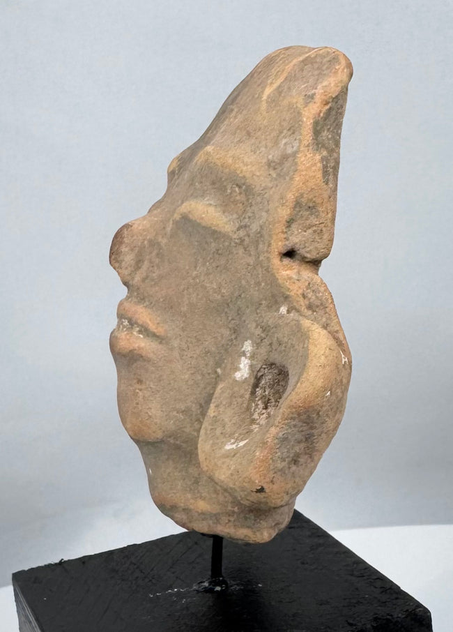 Museum-quality Pre-Columbian terracotta head mounted for display from a private collection.