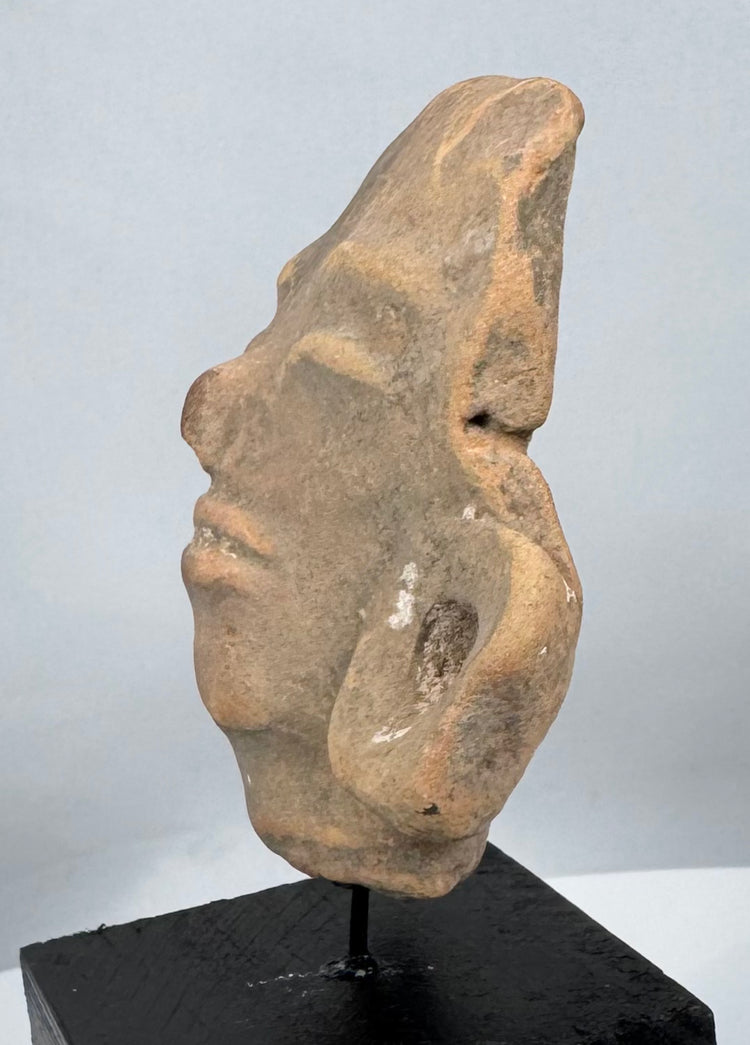 Museum-quality Pre-Columbian terracotta head mounted for display from a private collection.