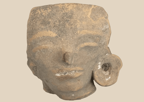 Pre-Columbian West Mexican terracotta head fragment with large ear spool mounted on a custom display stand.