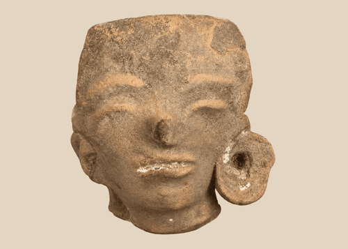 Pre-Columbian West Mexican terracotta head fragment with large ear spool mounted on a custom display stand.