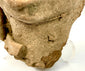 Macro detail of rough granular texture on Pre-Columbian terracotta head base