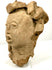 Three-quarter view of Mesoamerican terracotta head highlighting sculpted headdress depth