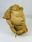 Pre-Columbian figurative terracotta head fragment with headdress, museum-style lighting