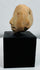 Ancient terracotta anthropomorphic head fragment exhibiting expressive features and long-term burial wear.