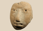 Pre-Columbian terracotta human head fragment with stylized facial features mounted on a custom display stand.