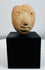 Archaeological terracotta human head fragment originally part of a larger ceremonial vessel or figure.