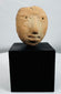 Archaeological terracotta human head fragment originally part of a larger ceremonial vessel or figure.
