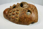 Ancient Central American mask with exaggerated eyes and sculptural form