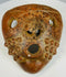 Pre-Columbian ritual mask with perforations and expressive form