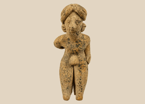 Pre-Columbian West Mexican terracotta standing figure, circa 300 BCE–500 CE, hand-modeled with tall turban-style headdress, stylized proportions, and surface encrustations, mounted on acrylic display base