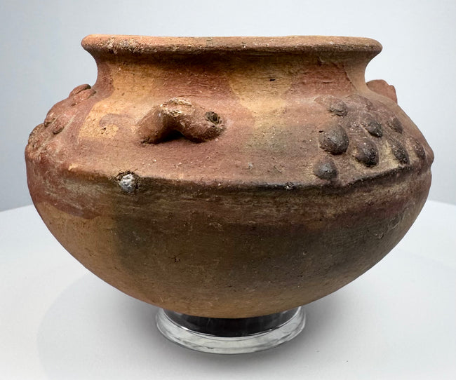 Pre-Columbian clay vessel, circa 800–1500 CE, with reddish-brown earthenware body and decorative relief elements.