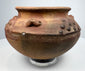 Pre-Columbian clay vessel, circa 800–1500 CE, with reddish-brown earthenware body and decorative relief elements.