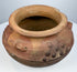 Ancient Mesoamerican or Andean pottery vessel with sculpted surface motifs and hand-formed terracotta construction.