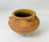 Hand-molded terracotta vessel featuring sculpted motifs and ceremonial use