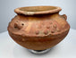 Ancient terracotta ritual vessel from the Americas with molded ornament and compact hand-crafted form.