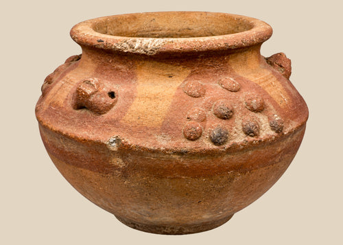 Pre-Columbian terracotta vessel from Central or South America, 800–1500 CE, featuring raised decorative clusters and sculpted motifs. Hand-molded clay vessel reflects Mesoamerican or Andean ritual and ceremonial craftsmanship, highlighting fertility and spiritual symbolism in ancient civilizations.