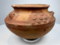 Ancient Central or South American terracotta vessel displaying raised motifs and traditional Pre-Columbian ceramic craftsmanship.
