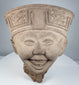 Classic Veracruz Sonriente terracotta head with expressive smile and elaborate geometric headdress