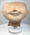 Ancient Mexican smiling face ceramic head from Veracruz with rounded cheeks and gently narrowed eyes