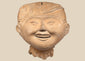 Pre-Columbian Veracruz Sonriente smiling face terracotta head with scroll-motif headdress, circa 600–900 CE