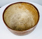 Geometric earthenware bowl with a broad open mouth and worn painted decoration.