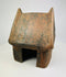 Pre-Columbian terracotta house model from West Mexico, front view on white background.