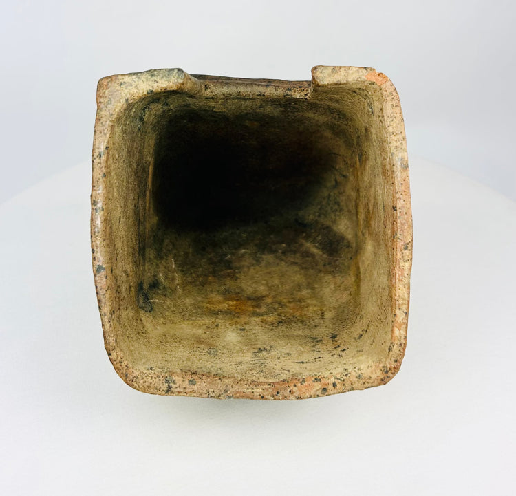 Pre-Columbian ceramic house shrine with mineral deposits and angled roof.