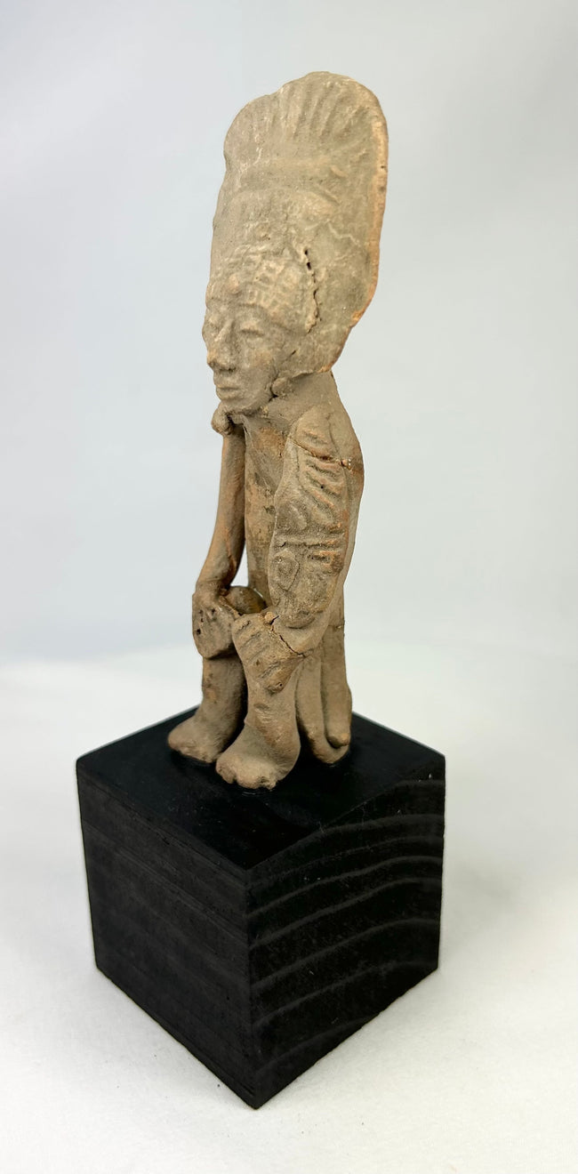Pre-Columbian terracotta standing figure with headdress, West Mexico, 300 BCE–500 CE, display-mounted