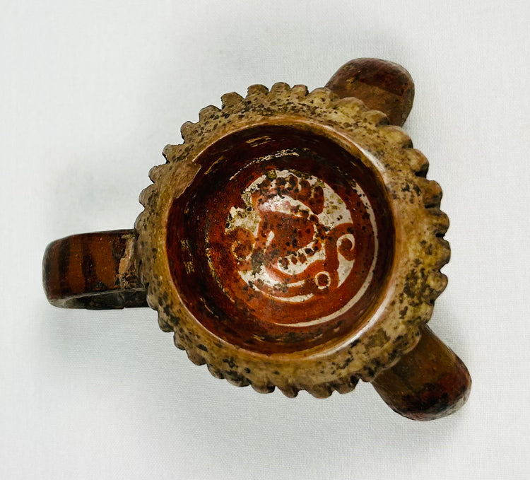 Pre-Columbian miniature tripod bowl with notched rim design