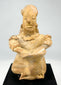 Hand-modeled ancient Mesoamerican terracotta drummer figure showing ear ornaments, drum, and earthen patina
