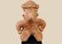 Pre-Columbian West Mexico terracotta figure with headdress on museum stand