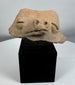 Ancient terracotta animal effigy fragment from the Pre-Columbian Americas mounted on a custom display stand.
