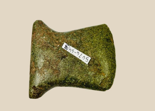 Small Pre-Columbian Andean ground-stone notched axe from Ecuador or Peru, circa 500–1500 CE. Utilitarian tool with steep beveled edge, rounded cutting surface, and side notches for hafting. Evidence of repeated sharpening and use-wear reflects practical daily use in woodworking and agriculture. Original archaeological tag included.