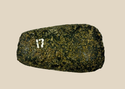 Pre-Columbian Andean ground-stone axe from Ecuador or Peru, 200–800 CE. Small utilitarian tool with fully ground faces, steep beveled cutting edge, and rounded use-worn edge. Archaeological numbering confirms provenance. Reflects daily life, practical craftsmanship, and durable stone-working technology of ancient Andean societies.