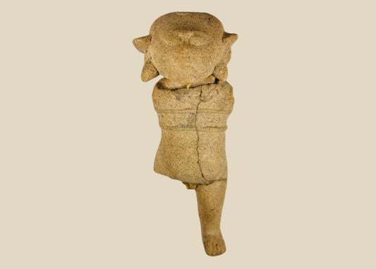 Ancient Pre-Columbian terracotta figurine with stylized facial features and unique headdress, likely Mayan or Zapotec, circa 500–1500 CE.