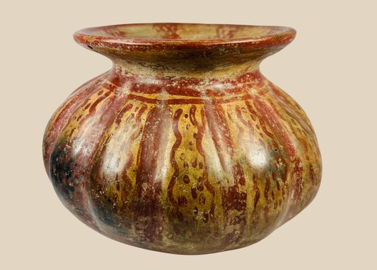Front view of a Pre-Columbian Moche-style globular ceramic vessel with red and beige painted bands.