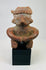 Pre-Columbian Nayarit terracotta seated figure with headdress on black display base.